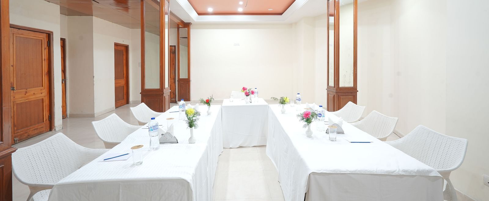 Conference hall with chairs and tables neatly arranged at DLS Hotels The Rock Castle.